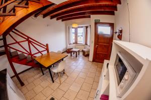 a living room with a staircase and a dining room at Cabaña 1 Comoda, Cálida y Confortable in Ushuaia