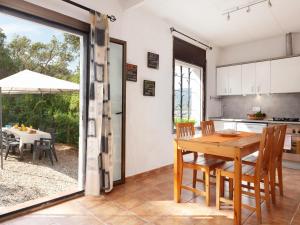 a kitchen and dining room with a table and chairs at BEAUTIFUL HOUSE in TOSSA in Tossa de Mar