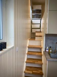 a staircase in a kitchen with a sink at Orres Guesthouse Stenhamra, Ekerö in Stenhamra