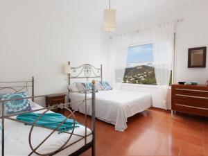 a bedroom with two beds and a window at BEAUTIFUL HOUSE in TOSSA in Tossa de Mar