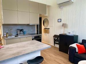a kitchen and living room with a couch and a counter at Orres Guesthouse Stenhamra, Ekerö in Stenhamra