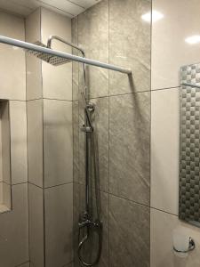 a shower with a glass door in a bathroom at The Nest JERMUK in Jermuk