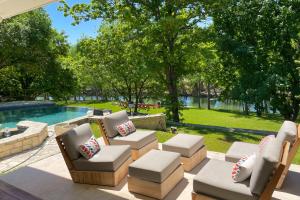 a patio with chairs and a pool with trees at Casa Maybanke in Hunt