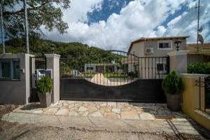 a black gate with a playground behind it at Irini's country house in Gouvia