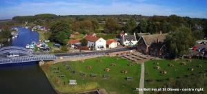 an aerial view of a village next to a river at Blue Cabin Bridge Stores in Fritton Norfolk