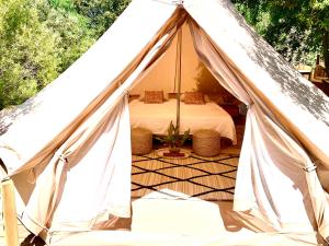 a canvas tent with a bed in it at Corsica Natura #2 in Coti-Chiavari