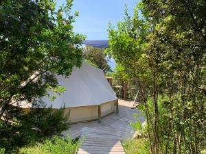 a large white tent in the middle of trees at Corsica Natura Glamping in Coti-Chiavari