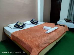 two beds with towels and pillows on top of them at Debbhumi Regency in Sāngla +37 photos