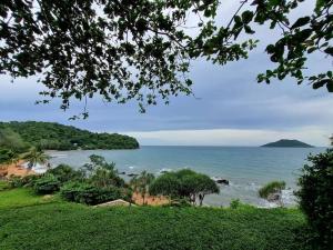 a view of a beach with trees and the ocean at Anatta The Cliff House in Chanthaburi