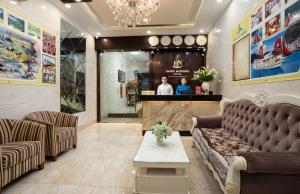 a lobby of a store with a couch and a counter at Hanoi Morning Hotel in Hanoi