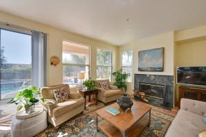 a living room with a fireplace and a tv at Luxury Encinitas Vacation Rental with Private Pool in Encinitas
