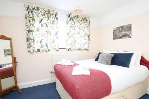 Schlafzimmer mit einem Bett und einem Fenster mit Vorhängen in der Unterkunft Wolsey Road, North Oxford in Oxford