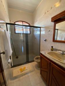 a bathroom with a shower and a sink and a toilet at Casa Raiz in Valença