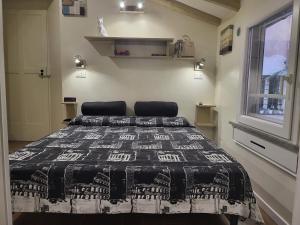 Un dormitorio con una cama con una manta blanca y negra. en The Fox Cove, en Roma 10 fotos más