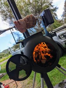 a grill with a hot dog and food cooking at Far View - Pet Friendly, Free Wifi in Venus Bay