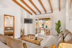 a living room with a couch and a tv at Sensacions Menorca-Son Xoriguer in Son Xoriguer