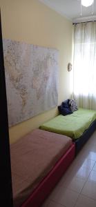 een kamer met 2 bedden en een kaart aan de muur bij La casa di Miretta in Chieti