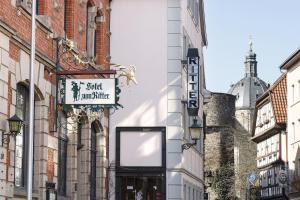a street with buildings and a sign for a soft drink centre at Hotel zum Ritter in Fulda