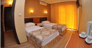 Postel nebo postele na pokoji v ubytování Epic Hotel