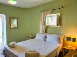 een slaapkamer met een wit bed, een raam en een stoel bij Le Pajare di Marina Serra di Casa Camilla Journey in Marina Serra