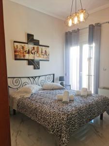 a bedroom with a bed with a black and white comforter at Luxury and Cozy Chios in Chios