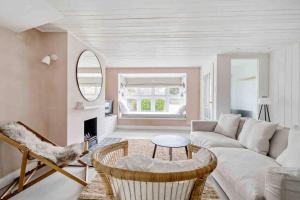 a living room with a couch and a table at sea side cottage near beach in West Wittering