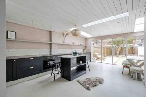 a kitchen with a counter and a stove top oven at sea side cottage near beach in West Wittering