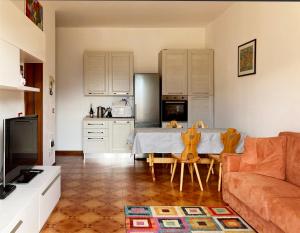 a living room with a couch and a table with chairs at Mountain view charming apartment in Moggio