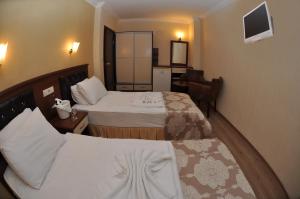 Postel nebo postele na pokoji v ubytování Epic Hotel