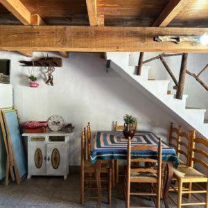 a dining room with a table and chairs and stairs at Granja El Regajo in Valencia