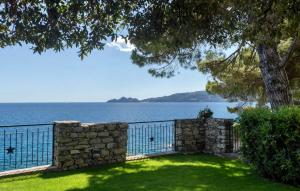 a yard with a stone fence and a view of the water at The best view in the world! in Zoagli