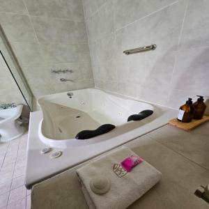 a white bath tub sitting in a bathroom at Rincon del Cerro in San Lorenzo