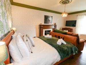 a bedroom with a large bed and a fireplace at The Old Post Office in Matlock