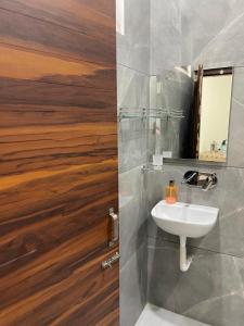 a bathroom with a sink and a mirror at Homestay Comforts 500m from Amritsar Airport in Amritsar +41 photos