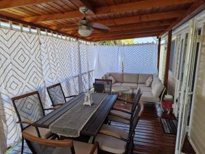 a patio with a table and chairs and a couch at Mobile Home Sea Fairy , Jezera , Murter in Tisno