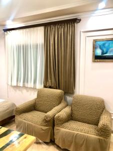 a living room with a chair and a window at Guest House Anahit Ijevan in Ijevan