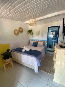 a bedroom with a bed and a blue door at É Hostel in Ouro Preto