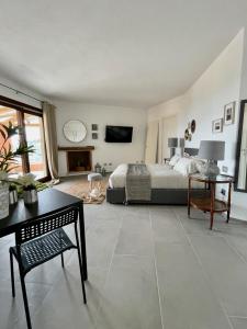 a large bedroom with a bed and a tv at bella vista Villasimius in Villasimius