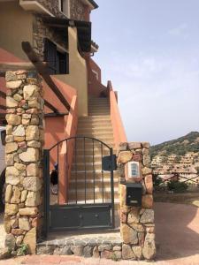 une porte menant à une maison avec un escalier et un bâtiment dans l'établissement bella vista Villasimius, à Villasimius