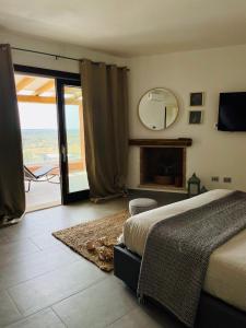a bedroom with a bed and a mirror on the wall at bella vista Villasimius in Villasimius