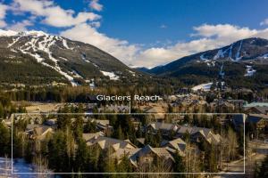 uma cidade nas montanhas com uma montanha coberta de neve em Glaciers Reach by Allseason Vacation Rentals em Whistler