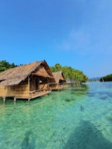 a group of overwater bungalows in the water at GAM BAY bungalow's in Besir