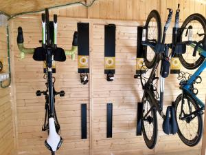 a wall with two bikes and hockey equipment at Eco Hotel Terrafranca in Frómista