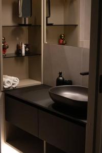 a bathroom with a bowl sink on a counter at New Chic & Minimal Old Town Flat in Kuressaare