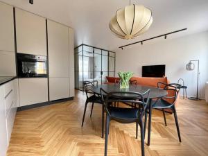 a kitchen and dining room with a table and chairs at New Chic & Minimal Old Town Flat in Kuressaare
