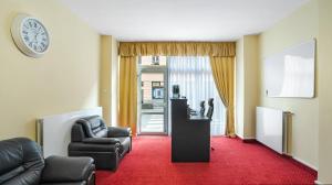 salon z kanapą, krzesłami i zegarem w obiekcie Aphrodite Suite Hotel Karlovy Vary w Karlowych Warach