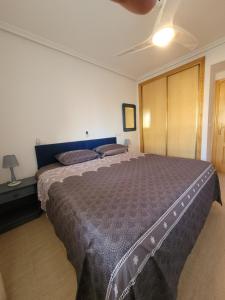 um quarto com uma cama grande num quarto em Palmerita 5 em Mar de Cristal