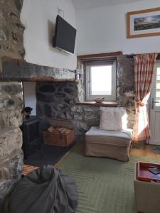 a living room with a couch and a window at Family stay by the beach in Chwilog