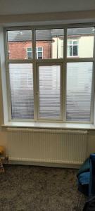 a room with a large window with blinds at Rydal house with office space newly refurbished in Newton-le-Willows