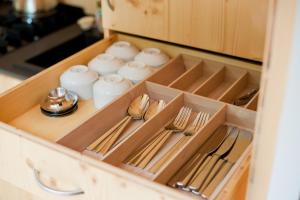 a wooden drawer with utensils in a kitchen at Tiny House Nature 2 Innenlage - Green Tiny Village Harlesiel in Carolinensiel